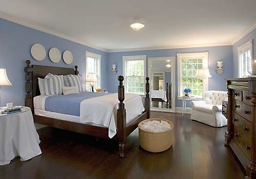 Placid blue walls and blanket in bedroom.