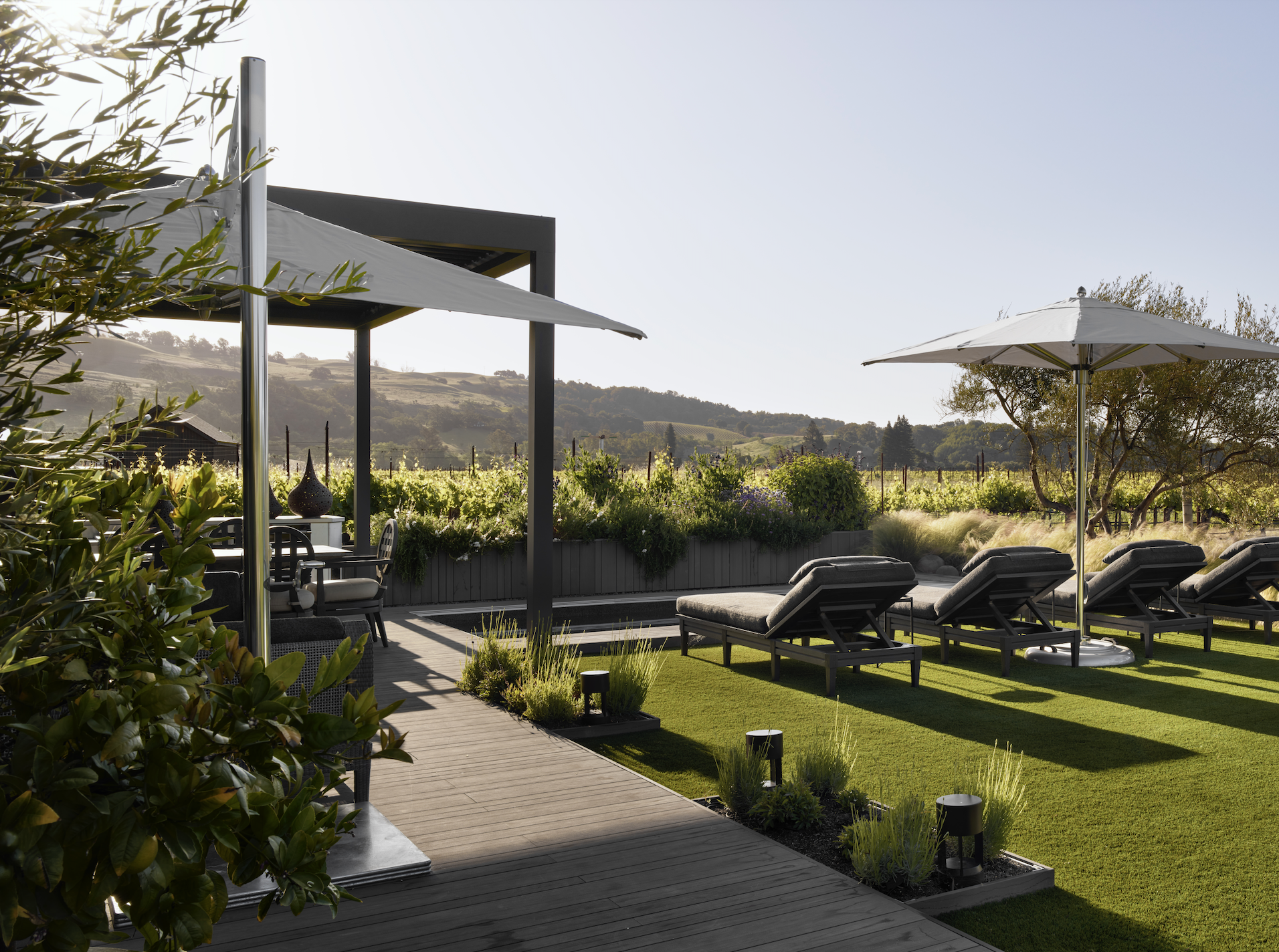 McGuire chaise lounges and Tuuci umbrellas enhance the experience of enjoying vineyard views. Photo by Jose Manuel Alorda.